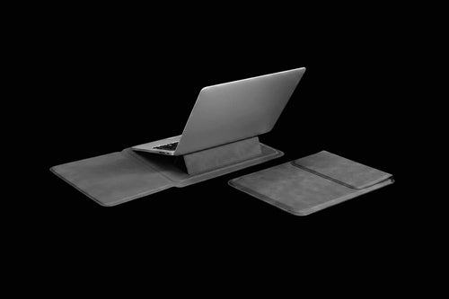 A dark gray laptop sleeve set shown on a black background, featuring a laptop in an open stand position and a matching closed sleeve beside it.